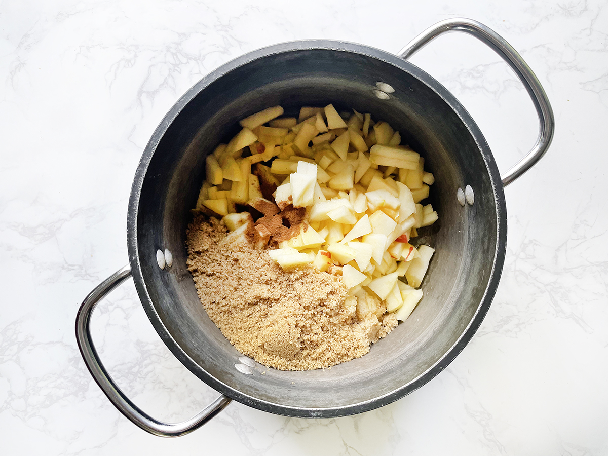 Chopped apples and brown sugar in a saucepan.