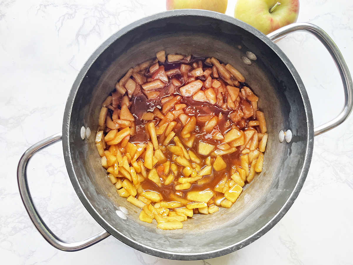 Cooked apple topping mixture in a saucepan.