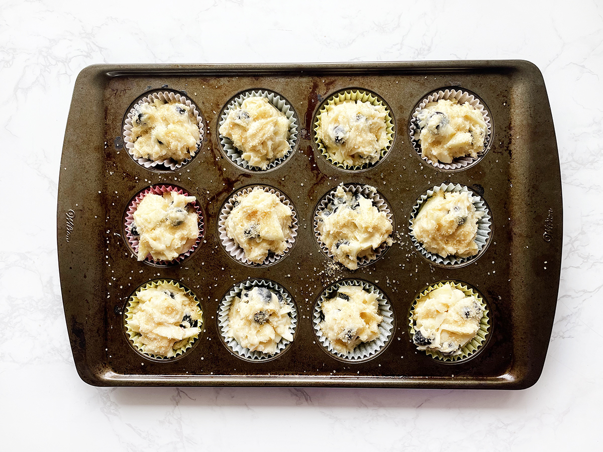 Muffin cups filled with muffin batter, ready to bake.