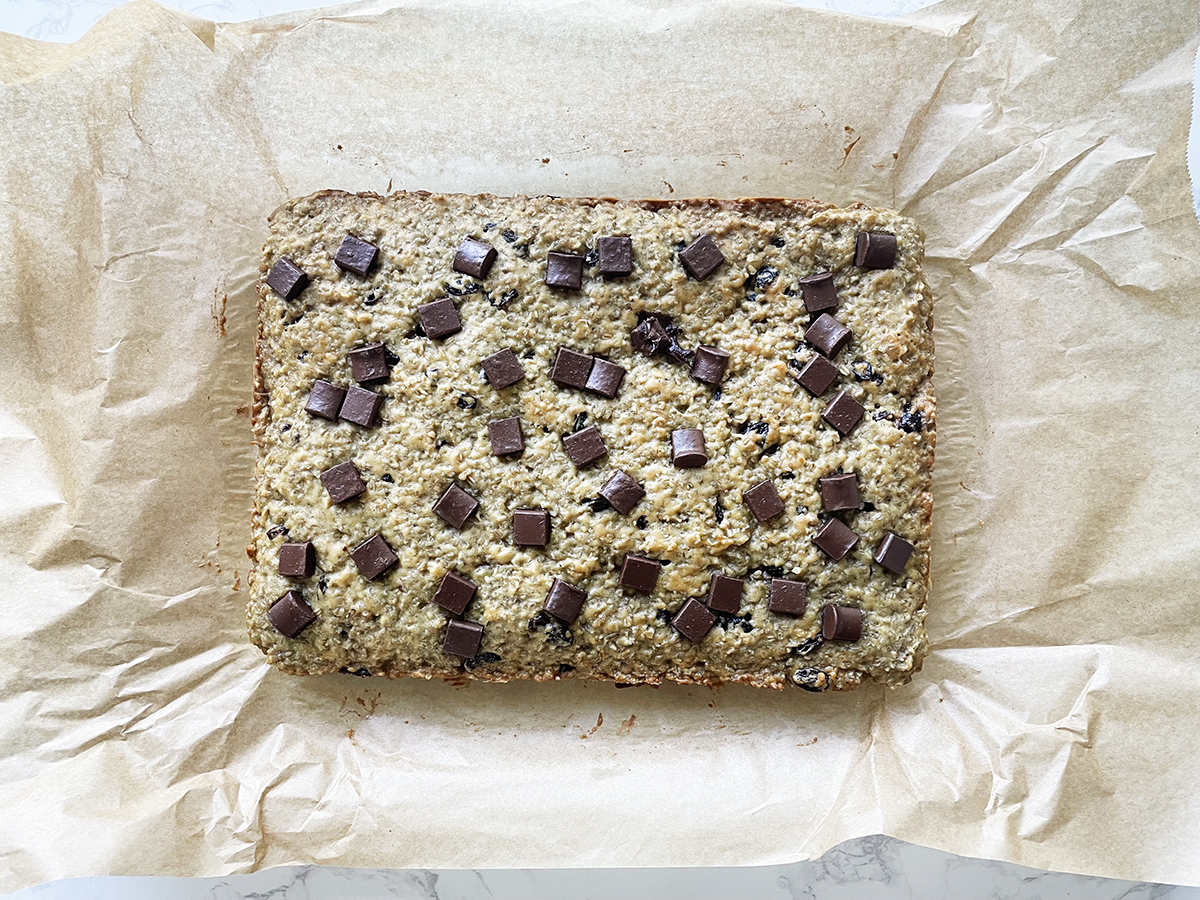 Steel cut oatmeal bars on parchment paper ready to slice and eat.