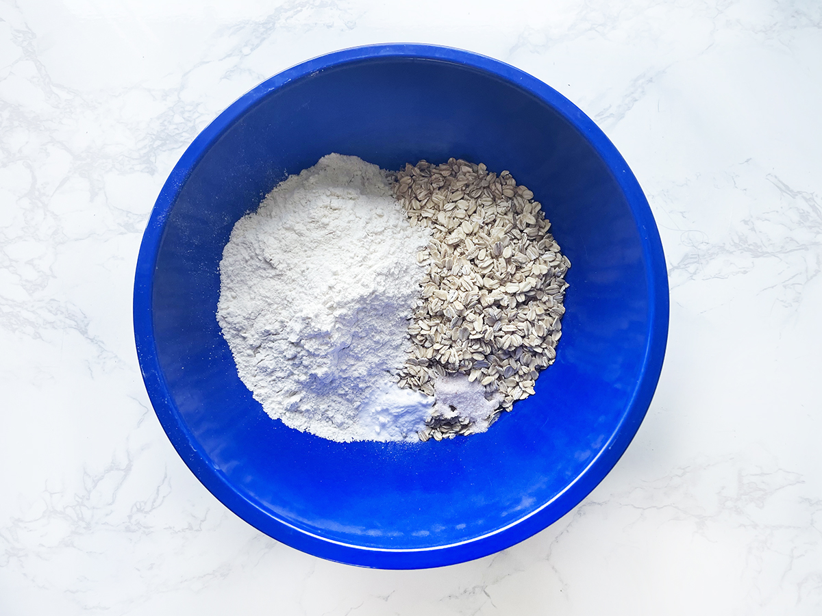 Dry ingredients in a blue bowl for oatmeal bars.