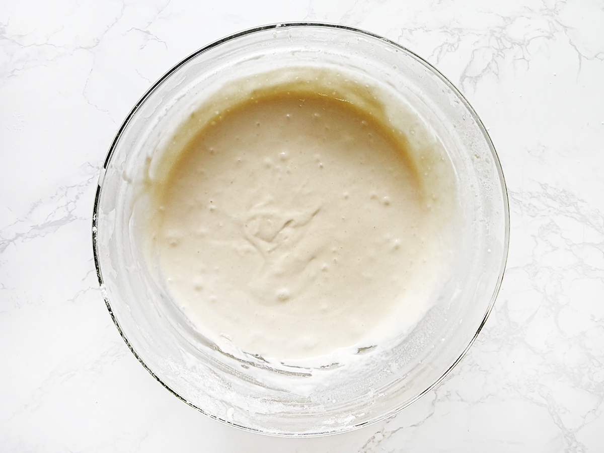 Thick pancake batter in a glass bowl.