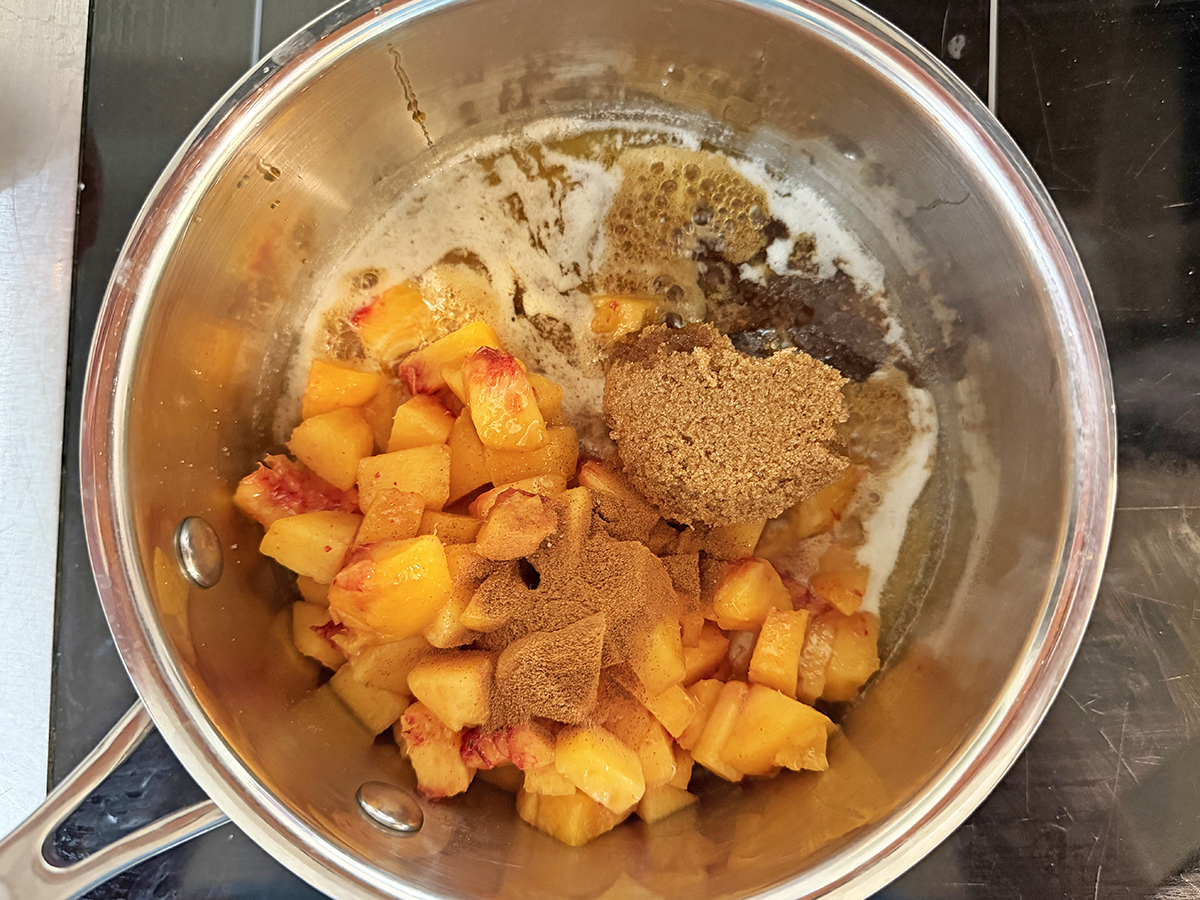 Ingredients for peach sauce in a saucepan.